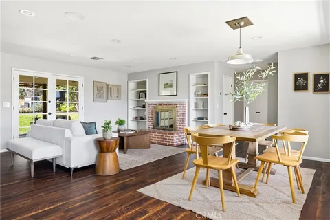 a living room with fireplace furniture and a wooden floor