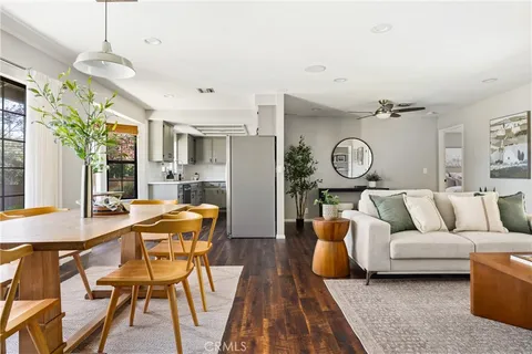 a living room with furniture a clock and a chandelier