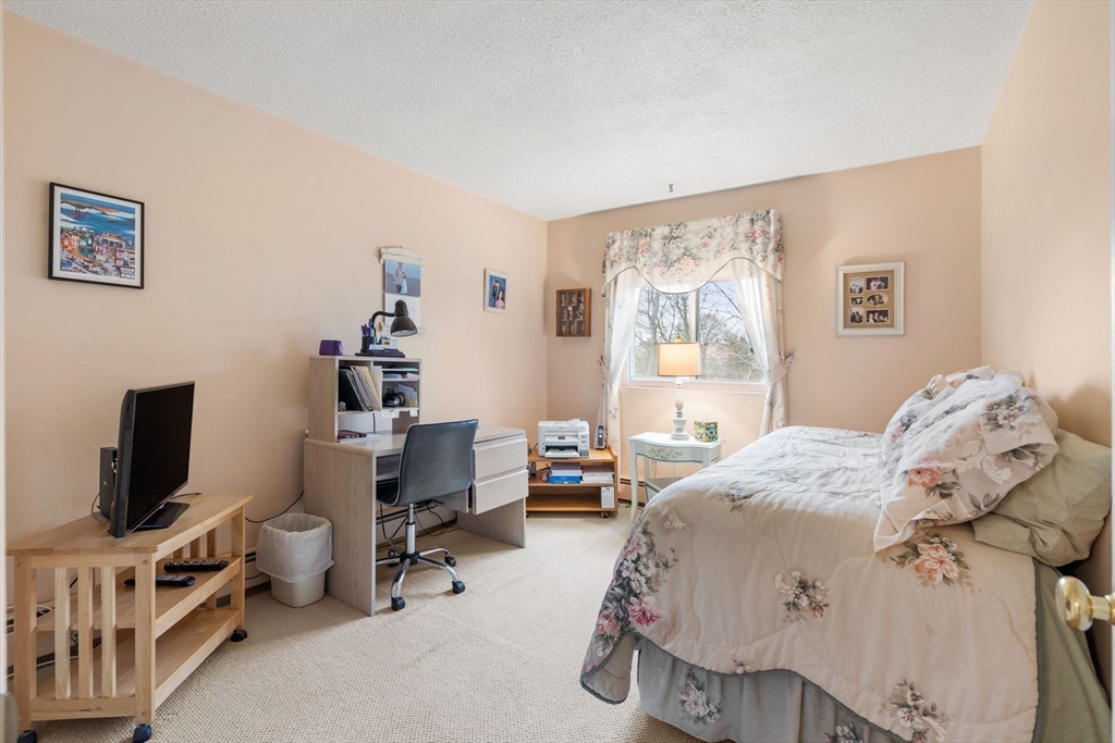 62 Purchase Street, Unit C5 Danvers, MA 01923 - Photo 16 of 22 a bedroom with a bed and a flat screen tv