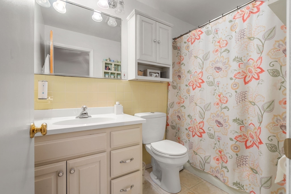 62 Purchase Street, Unit C5 Danvers, MA 01923 - Photo 19 of 22 a bathroom with a toilet sink and mirror