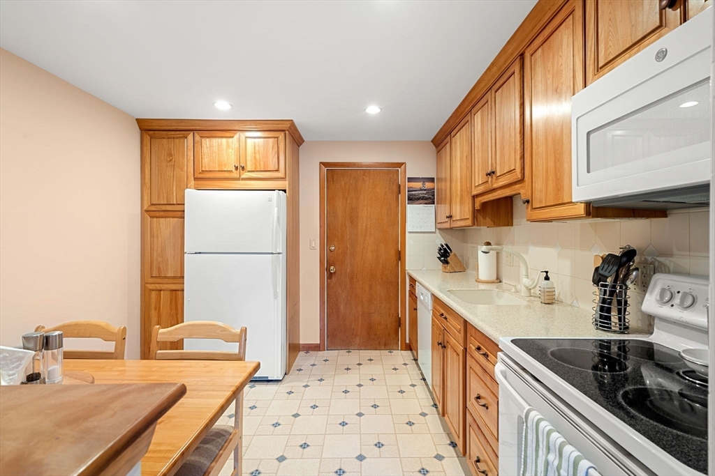 62 Purchase Street, Unit C5 Danvers, MA 01923 - Photo 3 of 22 a kitchen with stainless steel appliances sink refrigerator and stove