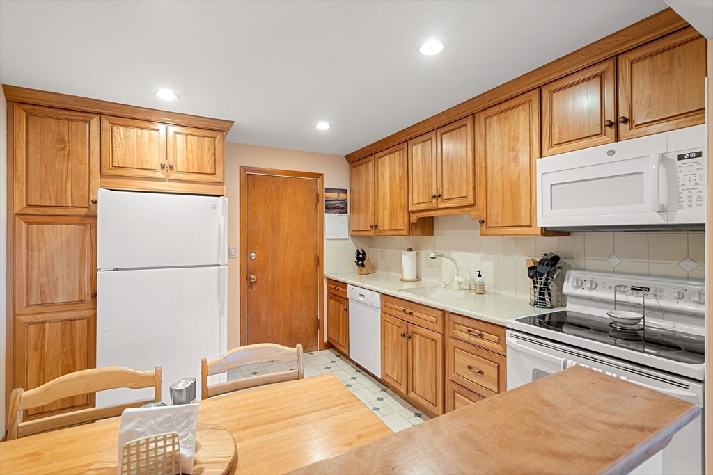 62 Purchase Street, Unit C5 Danvers, MA 01923 - Photo 7 of 22 a kitchen with stainless steel appliances granite countertop a refrigerator sink and cabinets