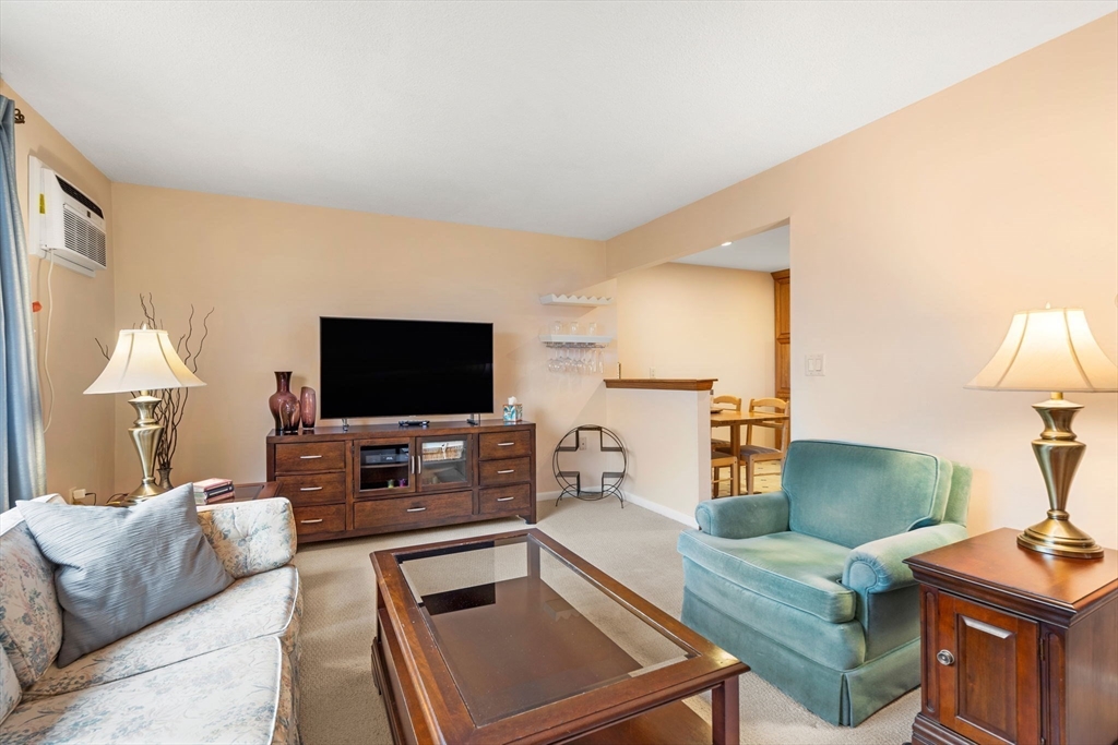 62 Purchase Street, Unit C5 Danvers, MA 01923 - Photo 8 of 22 a living room with furniture and a flat screen tv