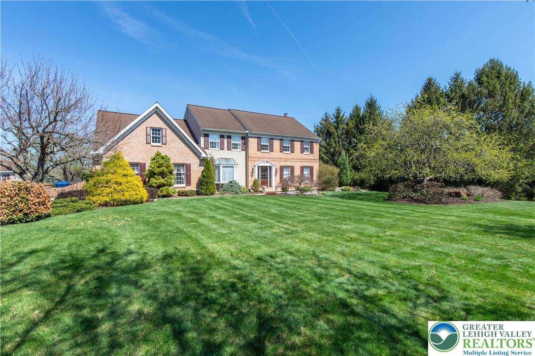 4059 Old Sentry Road Allentown, PA 18104 - Photo 3 of 39 A classic brick and siding residence is nestled amidst a meticulously manicured front yard and mature trees.