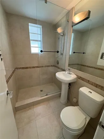 a bathroom with a toilet sink and shower