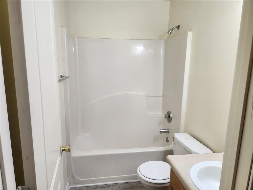 2935 Fields Drive Lithonia, GA 30038 - Photo 14 of 14 a bathroom with a toilet and a bath tub