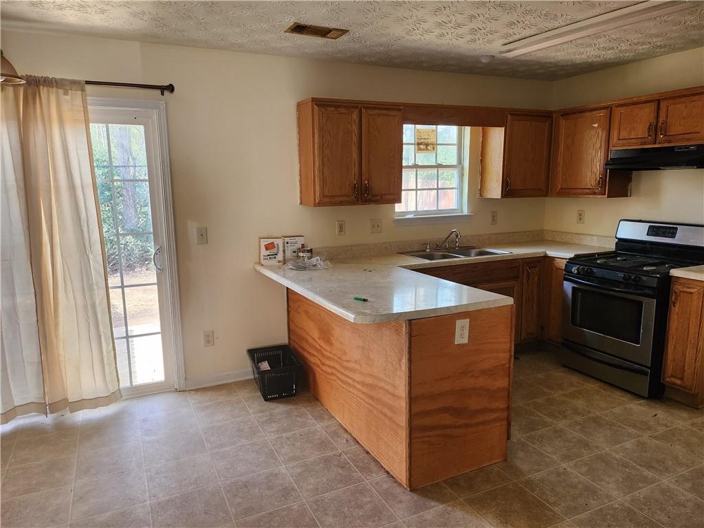 2935 Fields Drive Lithonia, GA 30038 - Photo 4 of 14 a kitchen with a stove sink and cabinets