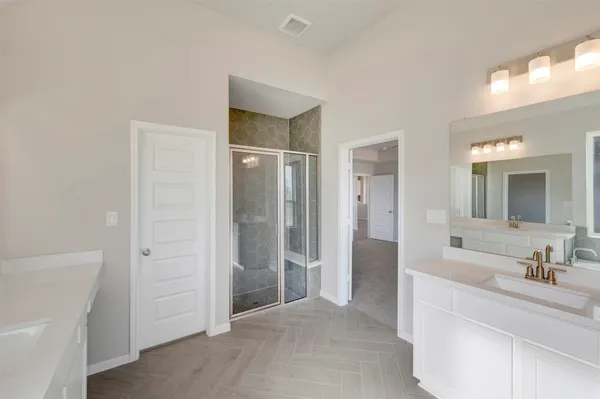a spacious bathroom with a shower and a sink