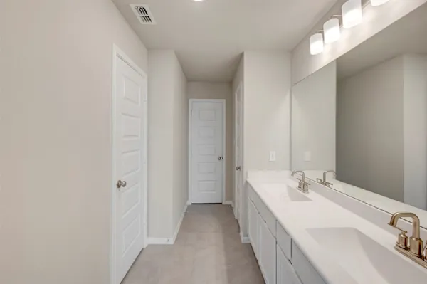 a bathroom with a double vanity sink and mirror