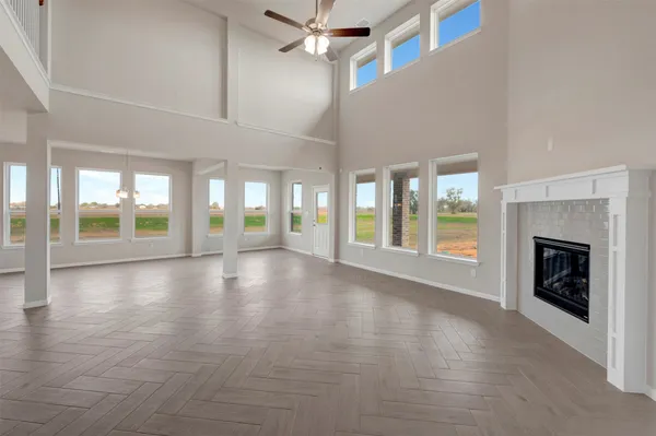 an empty room with wooden floor and fireplace