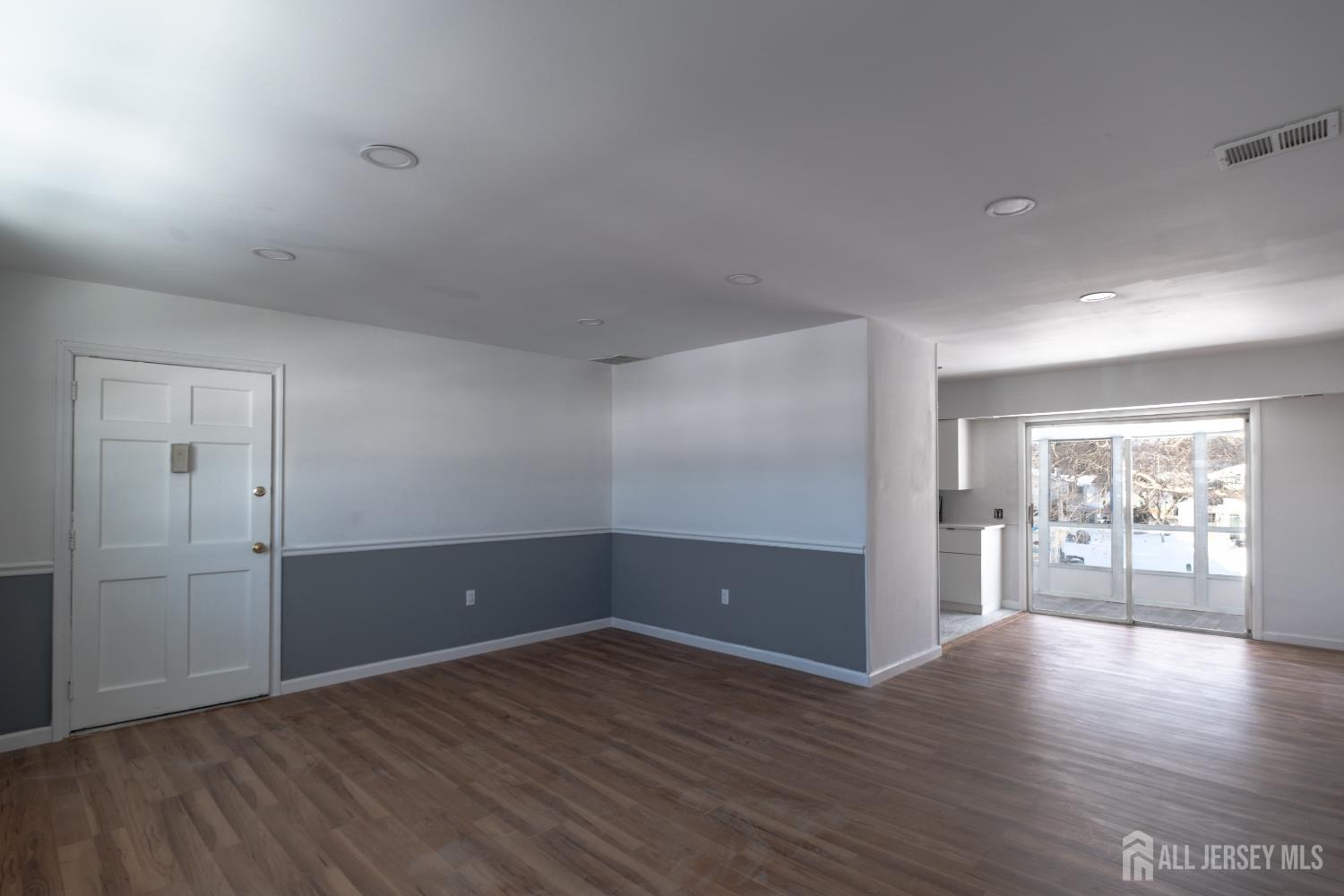72 Haven Drive, Unit D Matawan, NJ 07747 - Photo 4 of 12 wooden floor in an empty room with a window