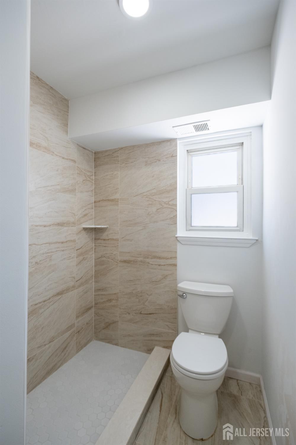 72 Haven Drive, Unit D Matawan, NJ 07747 - Photo 5 of 12 a bathroom with a toilet and a shower