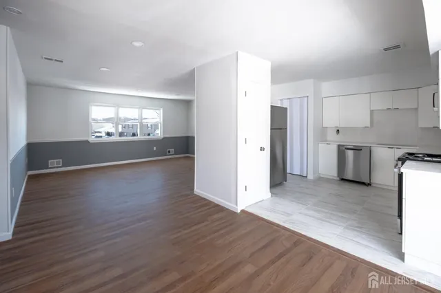 a view of a kitchen with a sink and a refrigerator