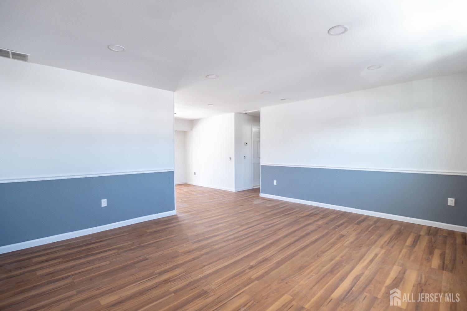 72 Haven Drive, Unit D Matawan, NJ 07747 - Photo 9 of 12 a view of an empty room with wooden floor
