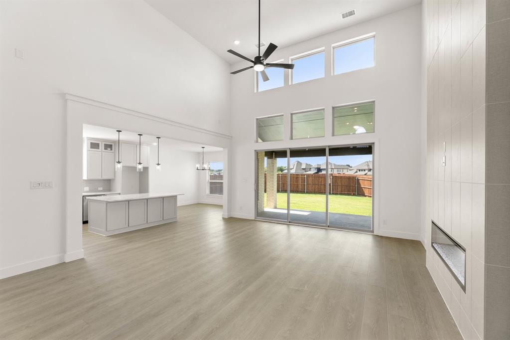 1617 Whisperwood Way Midlothian, TX 76065 - Photo 17 of 40 a view of an empty room with a window and wooden floor
