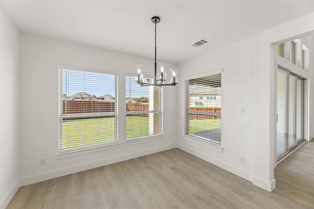 1617 Whisperwood Way Midlothian, TX 76065 - Photo 21 of 40 a view of an empty room with window and chandelier