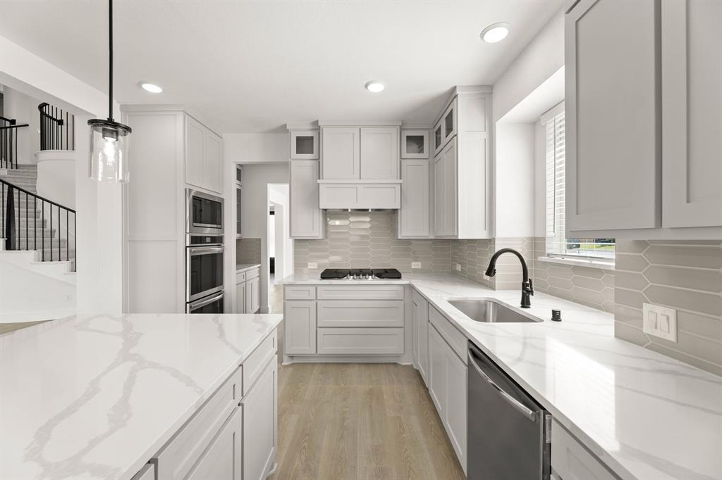 1617 Whisperwood Way Midlothian, TX 76065 - Photo 26 of 40 a kitchen with a sink stove and cabinets