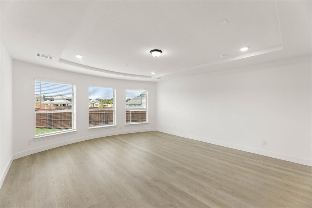 1617 Whisperwood Way Midlothian, TX 76065 - Photo 28 of 40 a view of an empty room with wooden floor and a window
