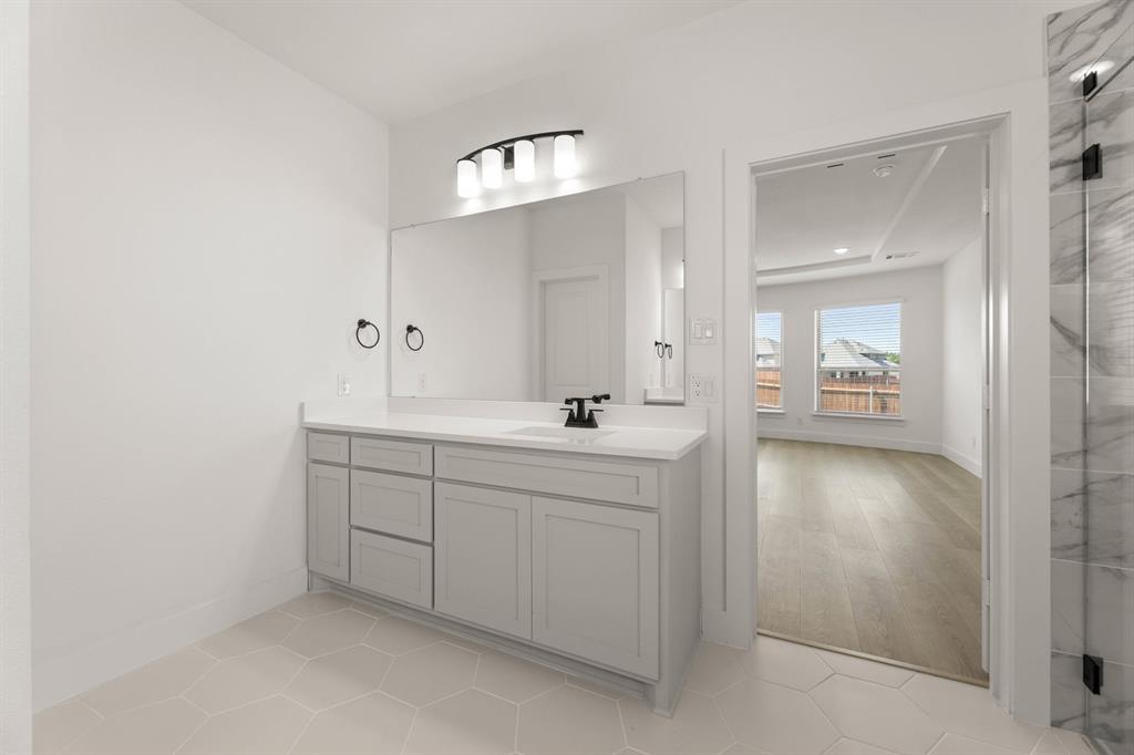 1617 Whisperwood Way Midlothian, TX 76065 - Photo 32 of 40 a bathroom with a sink a light fixture and a mirror