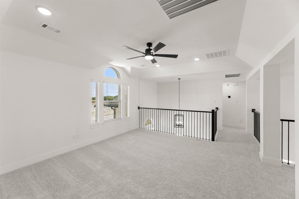 1617 Whisperwood Way Midlothian, TX 76065 - Photo 35 of 40 an empty room with ceiling fan and windows