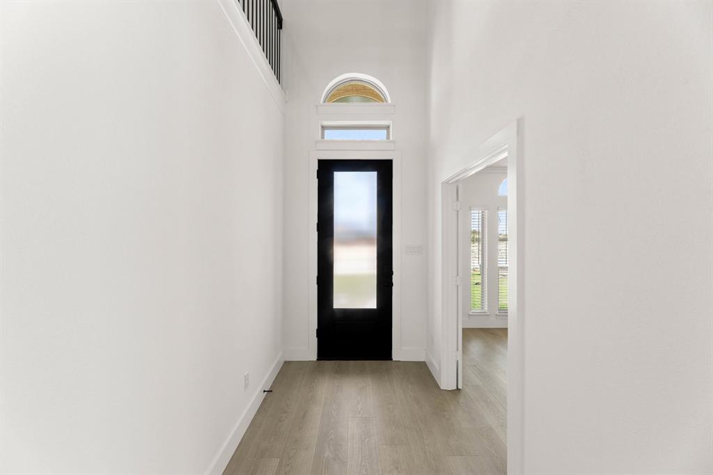 1617 Whisperwood Way Midlothian, TX 76065 - Photo 4 of 40 a view of empty room with wooden floor and wall