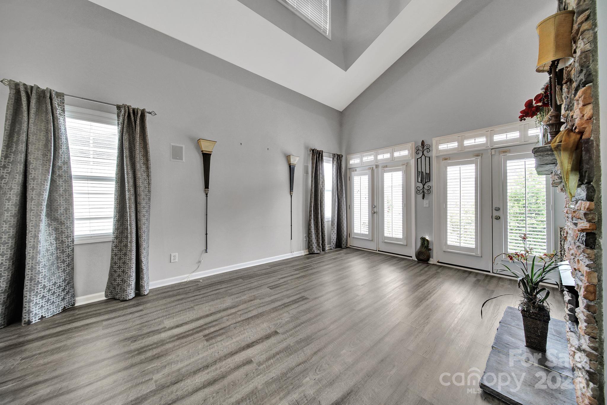 314 Wave Crest Drive Tega Cay, SC 29708 - Photo 11 of 39 a view of a livingroom with wooden floor and a large window