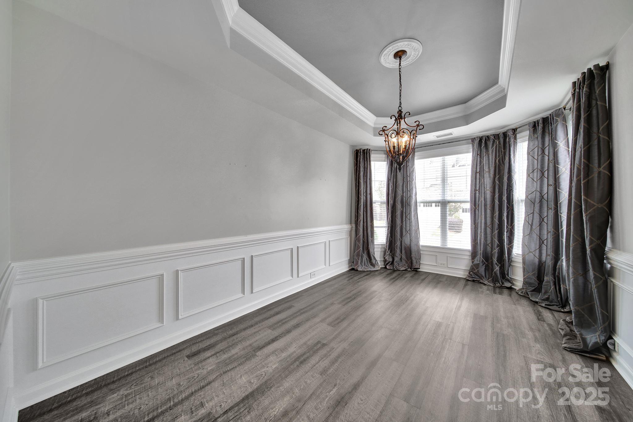 314 Wave Crest Drive Tega Cay, SC 29708 - Photo 13 of 39 a view of a room with wooden floor fan and windows