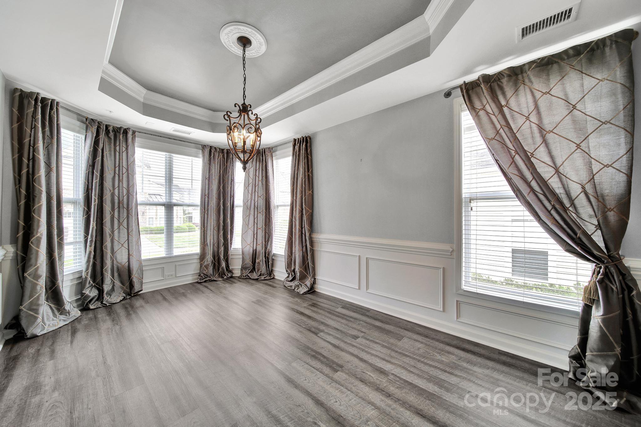 314 Wave Crest Drive Tega Cay, SC 29708 - Photo 14 of 39 a view of a livingroom with wooden floor and windows