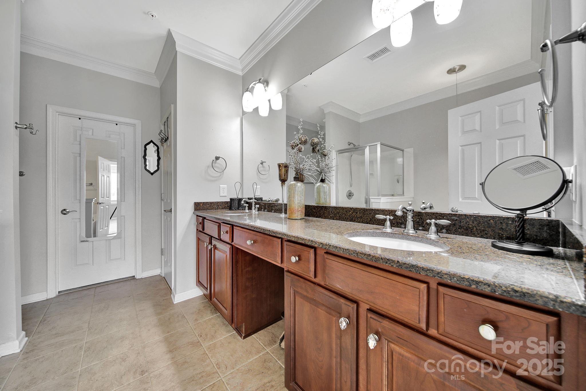 314 Wave Crest Drive Tega Cay, SC 29708 - Photo 19 of 39 a bathroom with double vanity sink and a mirror