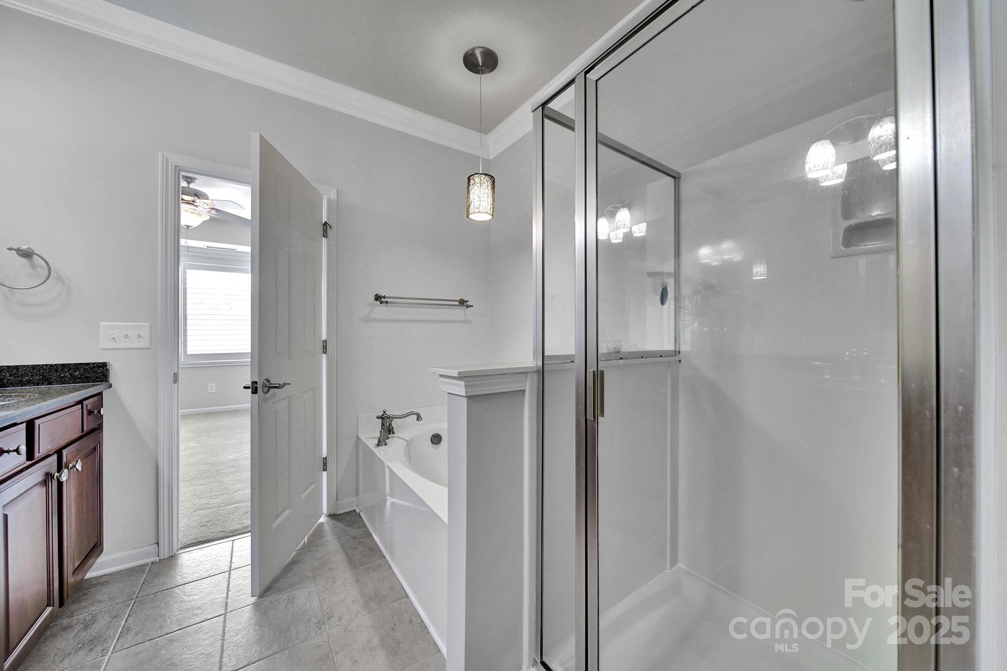 314 Wave Crest Drive Tega Cay, SC 29708 - Photo 20 of 39 a bathroom with a glass shower door and a sink