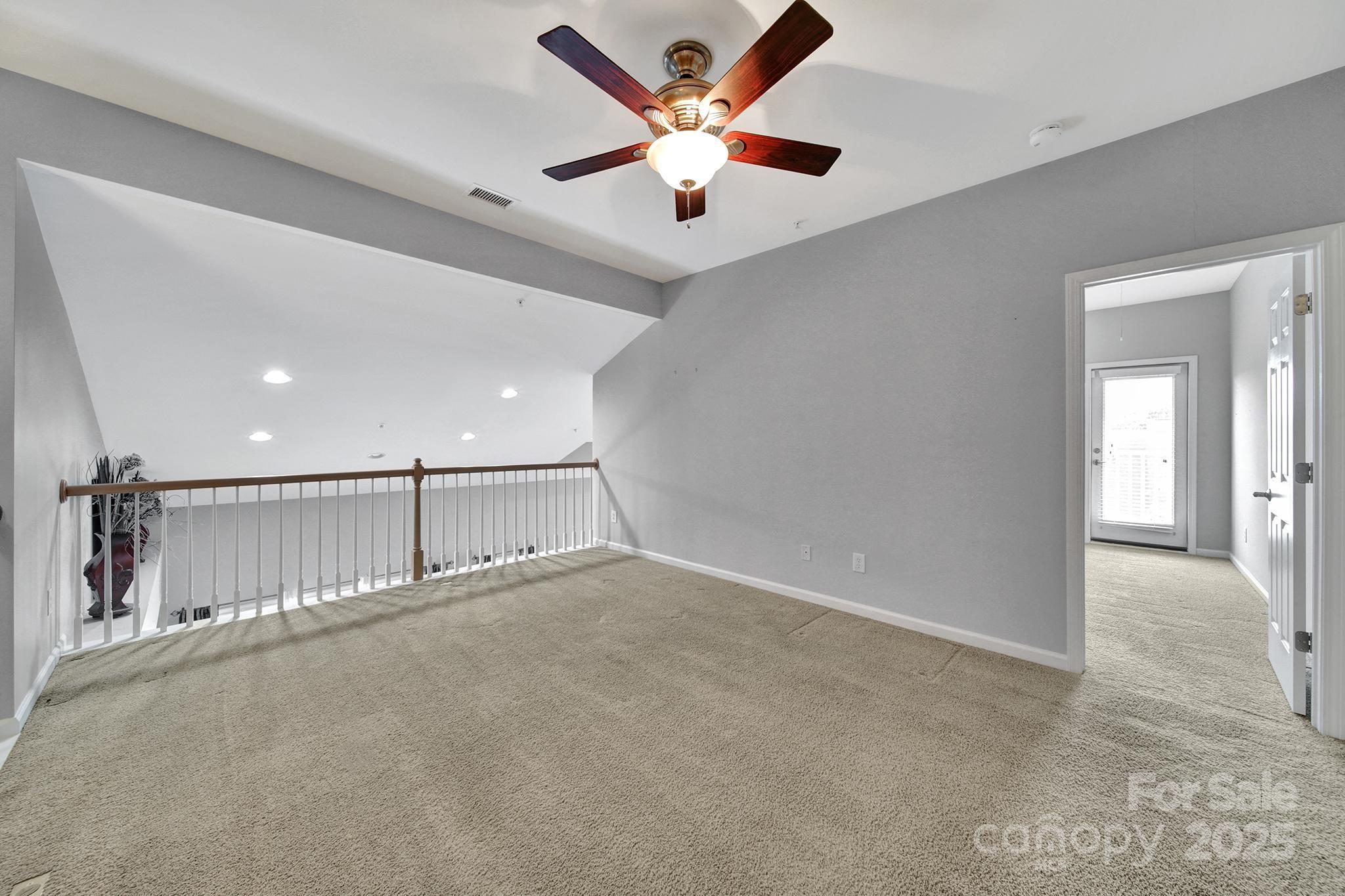 314 Wave Crest Drive Tega Cay, SC 29708 - Photo 23 of 39 an empty room with ceiling fan and windows