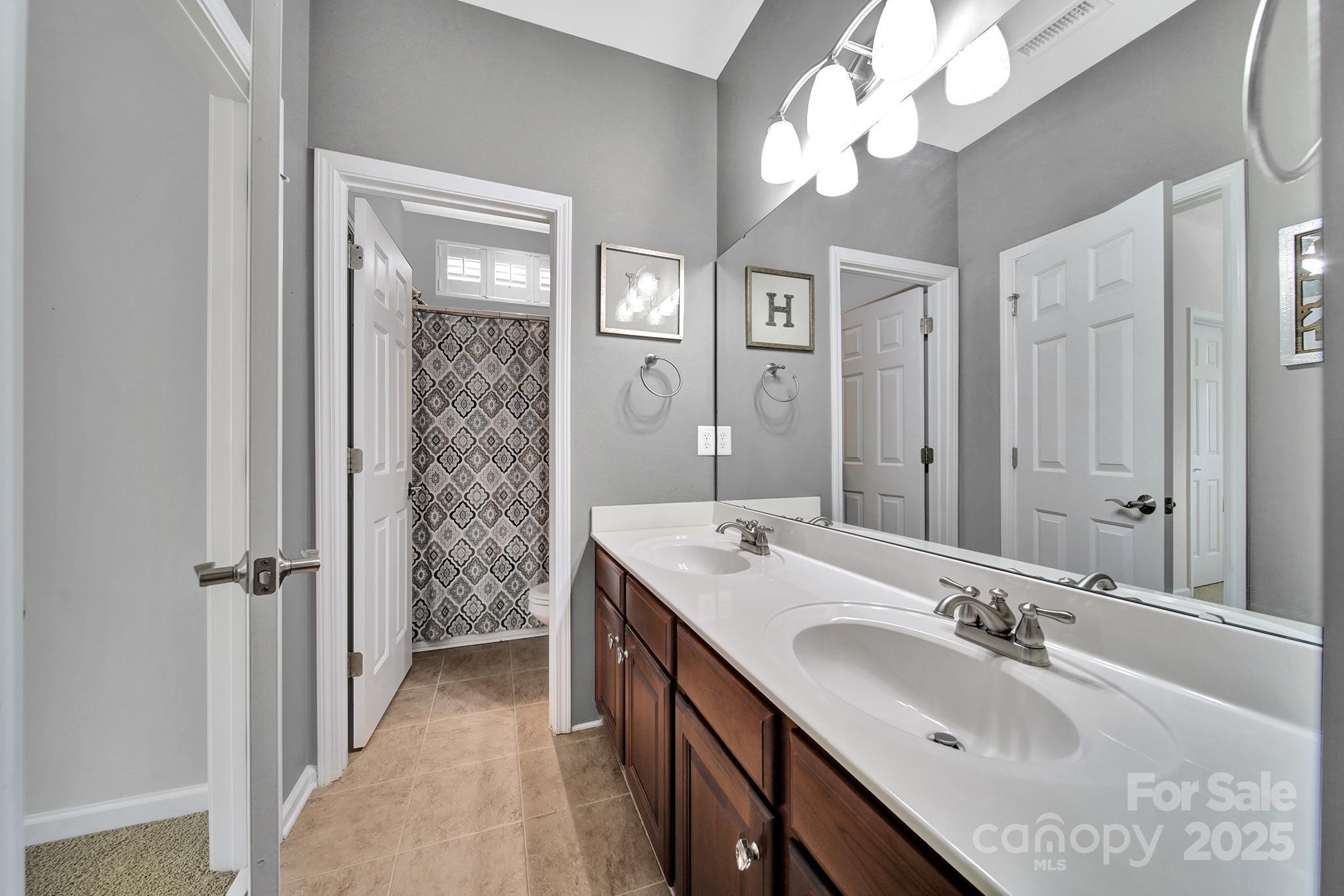 314 Wave Crest Drive Tega Cay, SC 29708 - Photo 26 of 39 a bathroom with a sink double vanity and a mirror