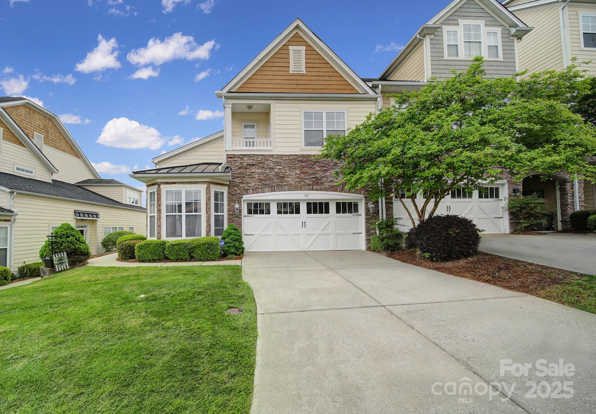 314 Wave Crest Drive Tega Cay, SC 29708 - Photo 36 of 39 a front view of a house with a yard and potted plants