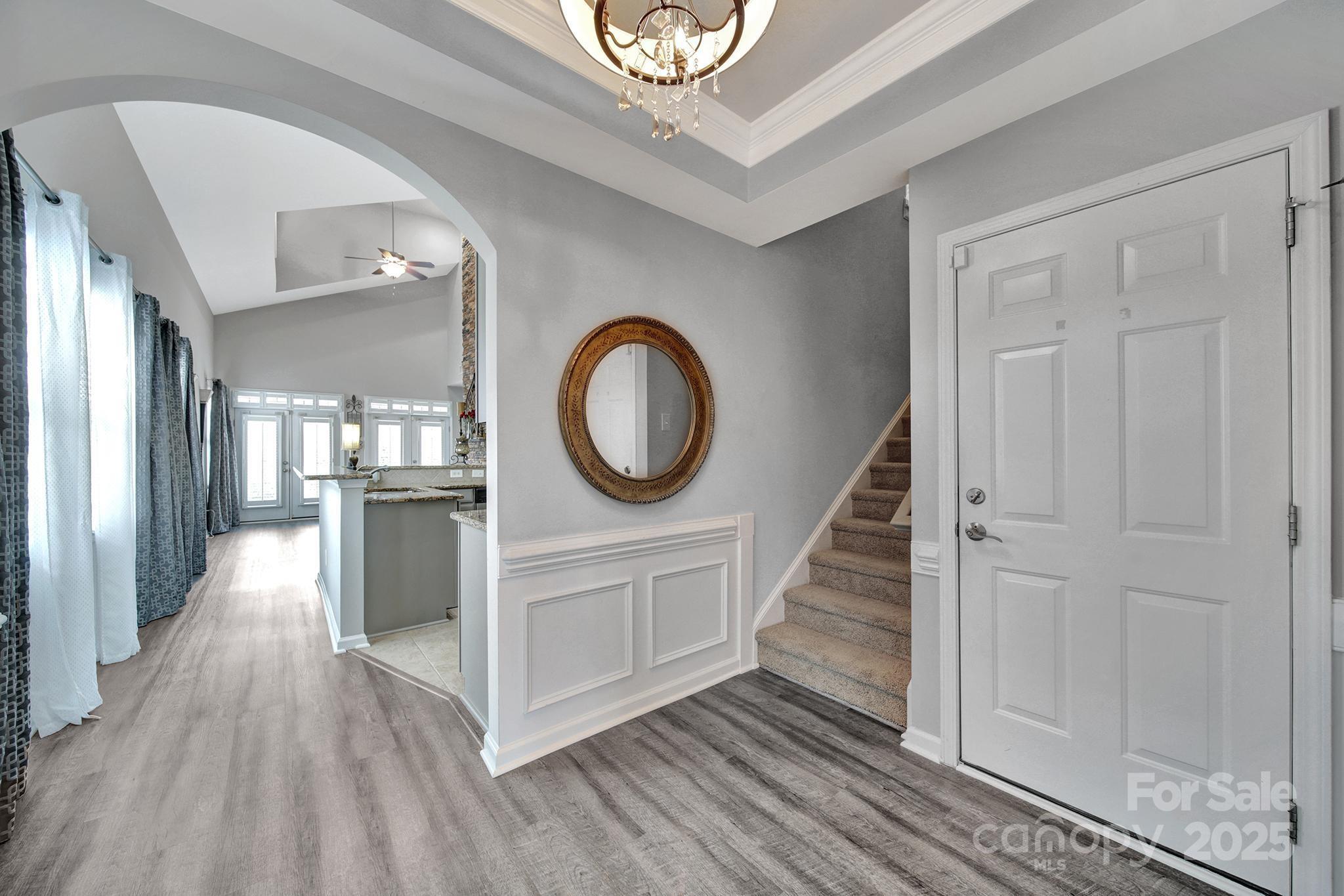 314 Wave Crest Drive Tega Cay, SC 29708 - Photo 4 of 39 a view of a hallway with wooden floor and staircase
