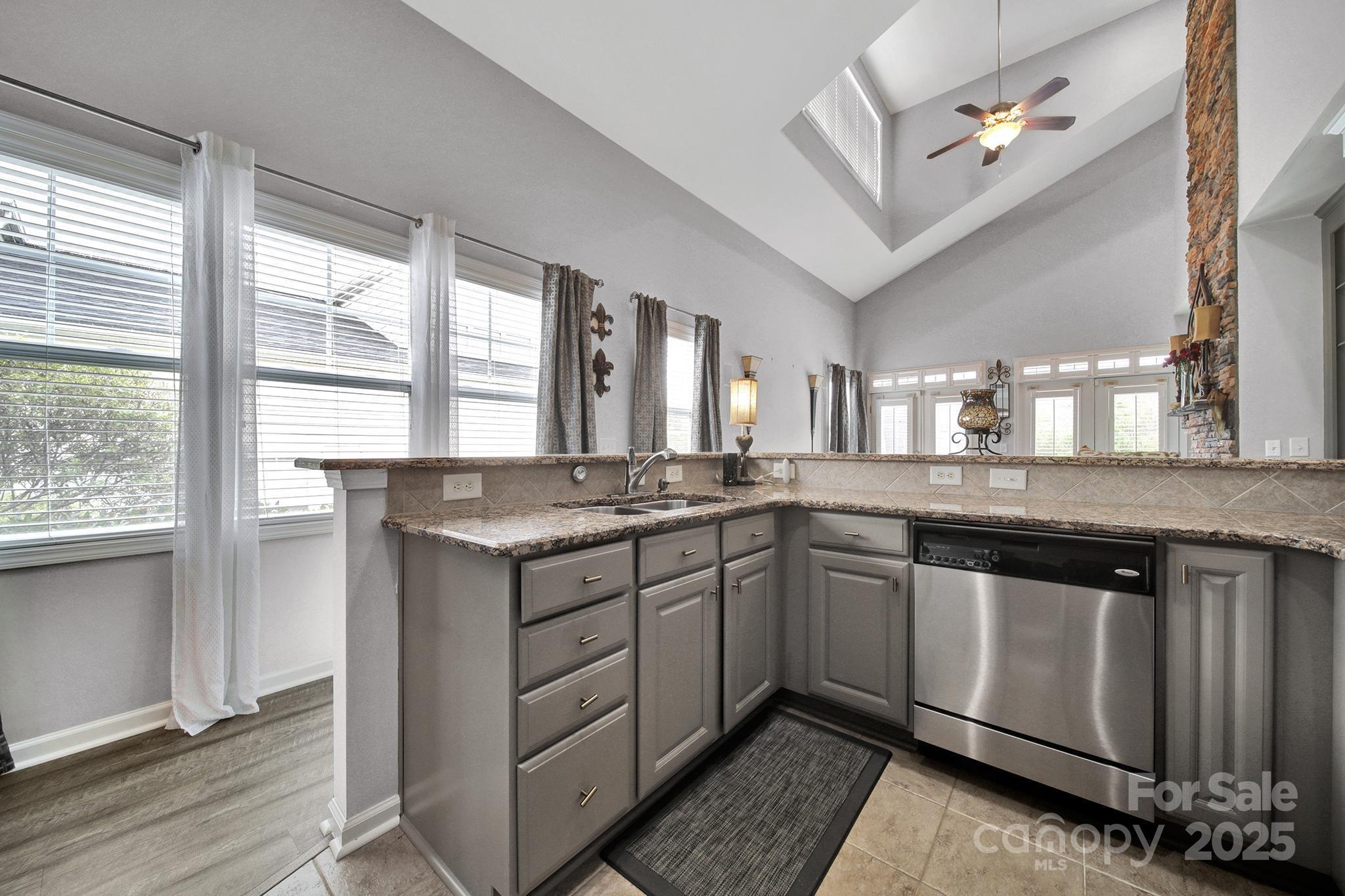 314 Wave Crest Drive Tega Cay, SC 29708 - Photo 6 of 39 a kitchen with granite countertop a sink stainless steel appliances and cabinets