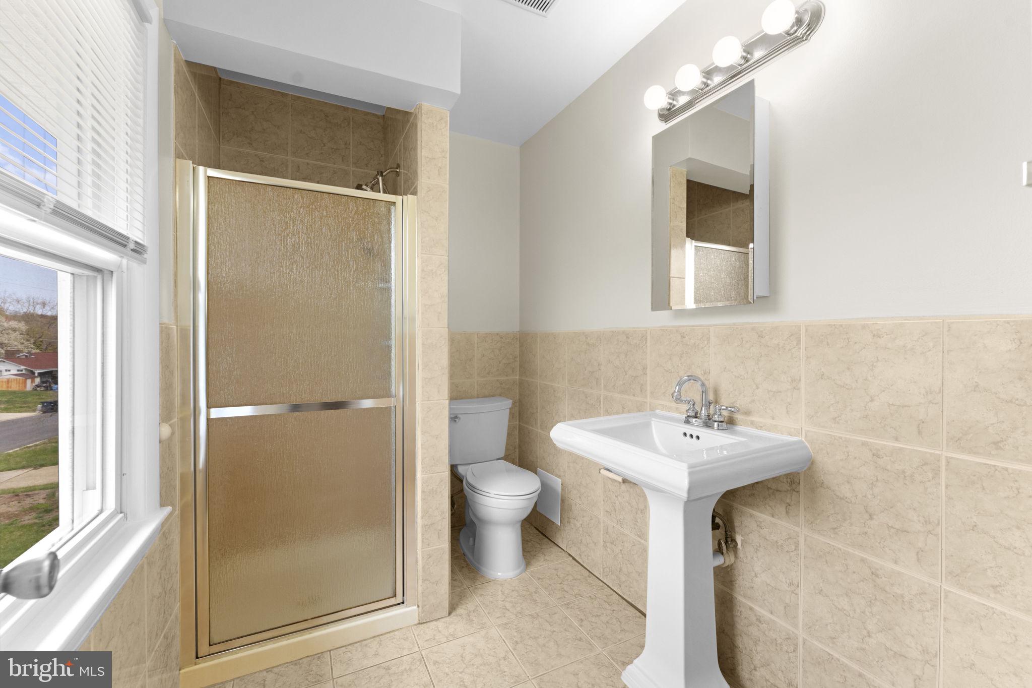 3003 Raymond Court Fort Washington, MD 20744 - Photo 25 of 30 a bathroom with a sink toilet and shower