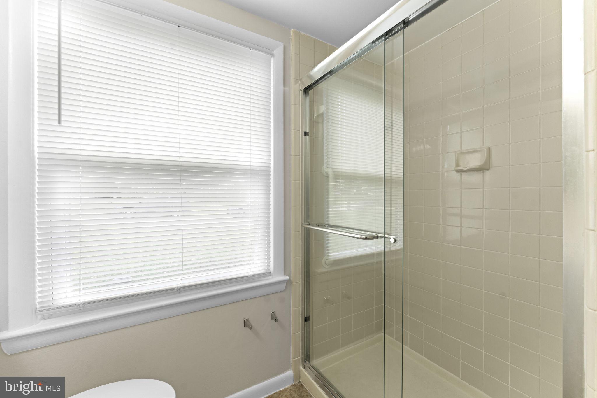 3003 Raymond Court Fort Washington, MD 20744 - Photo 10 of 30 a bathroom with a window and a shower
