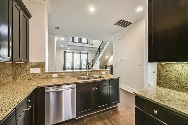 a kitchen with granite countertop a sink and a stove