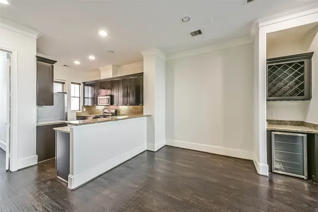 a kitchen with stainless steel appliances kitchen island granite countertop a refrigerator oven a sink and dishwasher