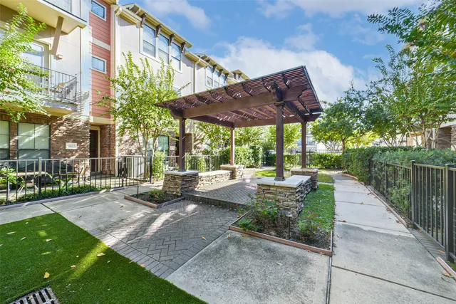 a view of a patio with table and chairs potted plants with wooden fence