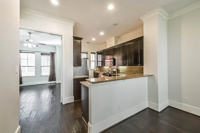 a kitchen with stainless steel appliances granite countertop a sink and cabinets