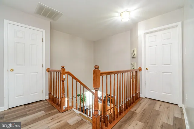 a bathroom with a bathtub a double vanity sink and a large mirror