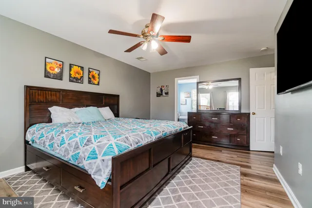 a bedroom with a bed and flat screen tv