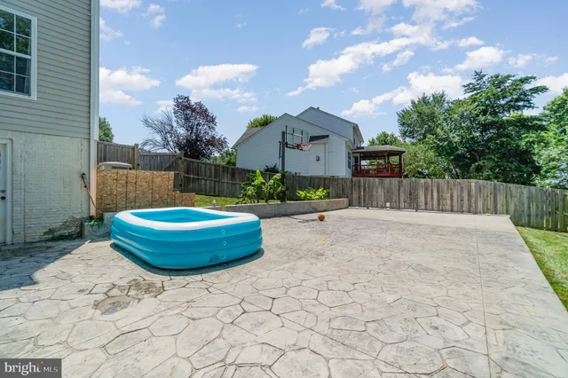 an aerial view of a residential houses with yard