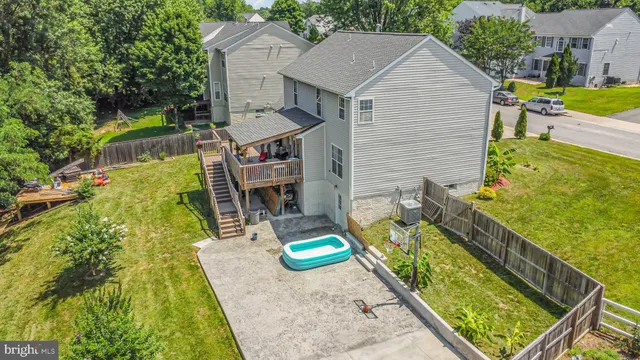 an aerial view of residential houses with outdoor space and trees
