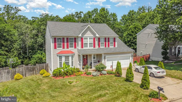an aerial view of residential houses with outdoor space and trees