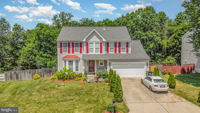 a view of a house with a yard and sitting area