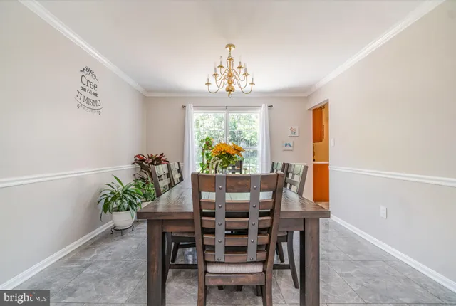 a view of a hallway with wooden floor and stairs