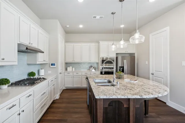 a kitchen with center island table and chairs