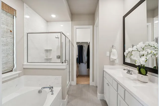 a bathroom with a bathtub sink and mirror